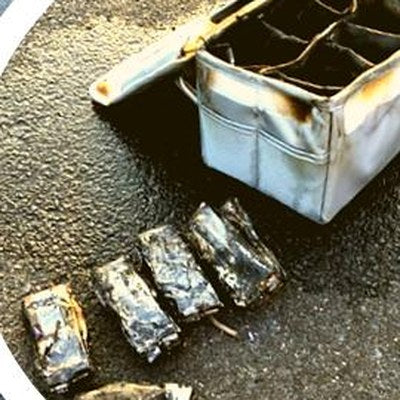 Burned-out LiPo batteries next to the box after the real fire test